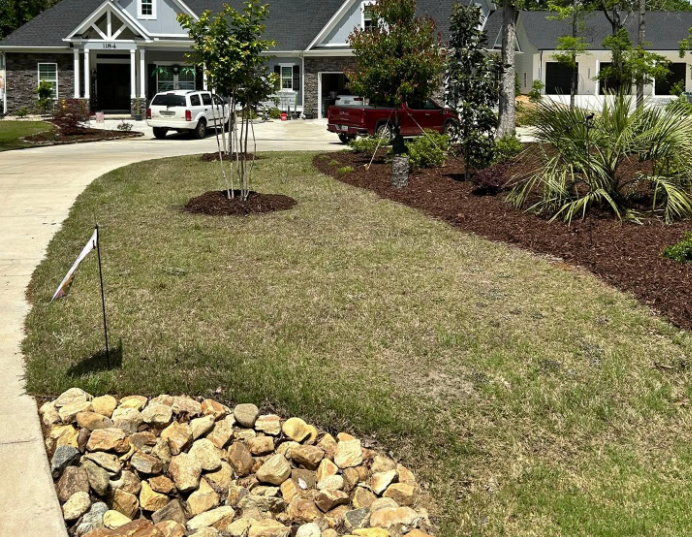 Finished landscaping with stone drainage feature